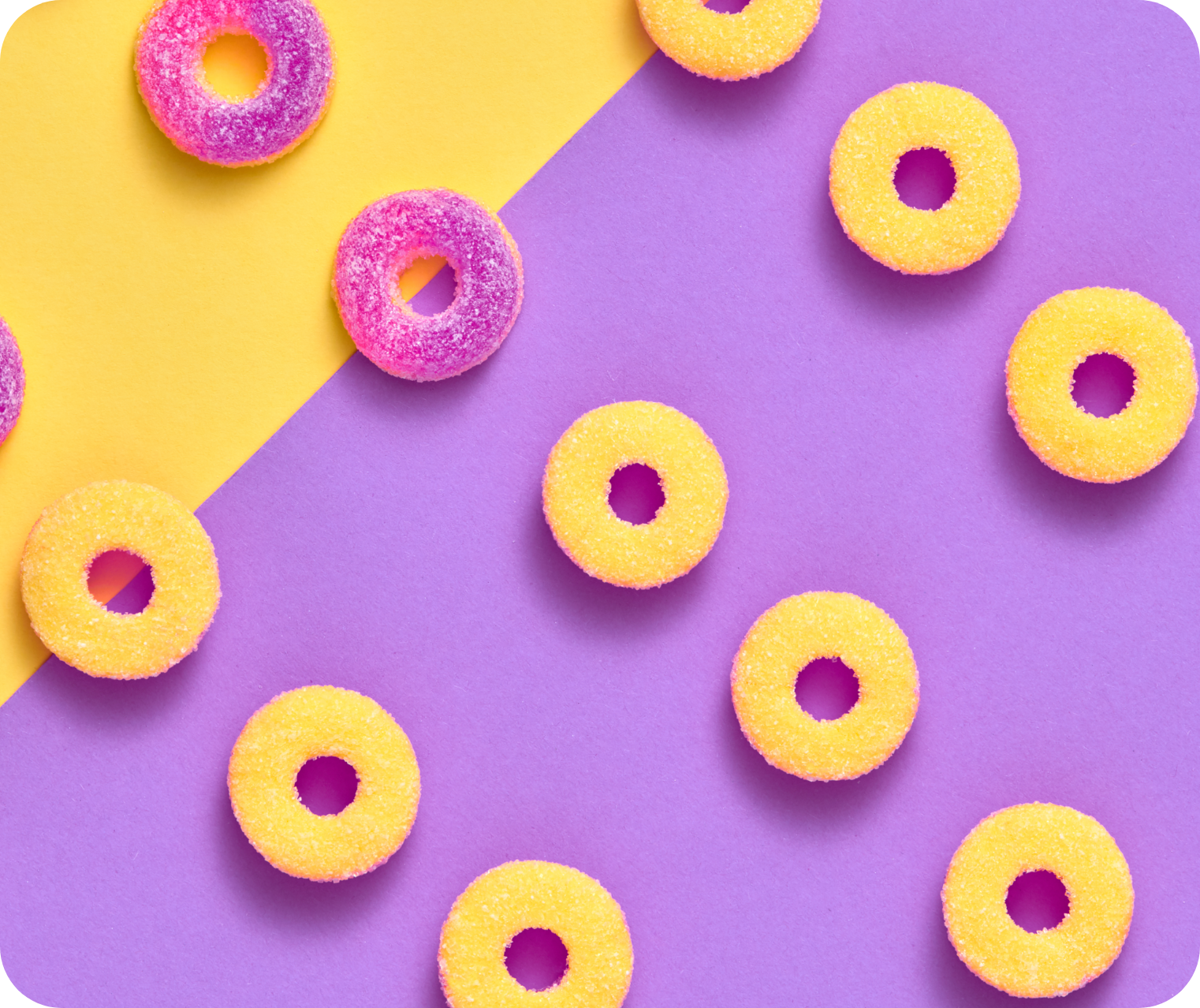 purple and yellow gummy rings flat lay